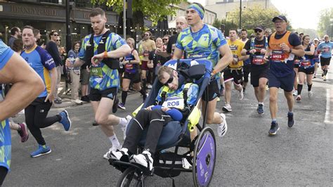 Kevin Sinfield carries friend and former teammate Rob Burrow across ...