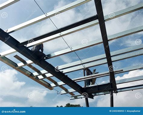 Construction Workers Installing Metal Roof Trusses at the Construction ...