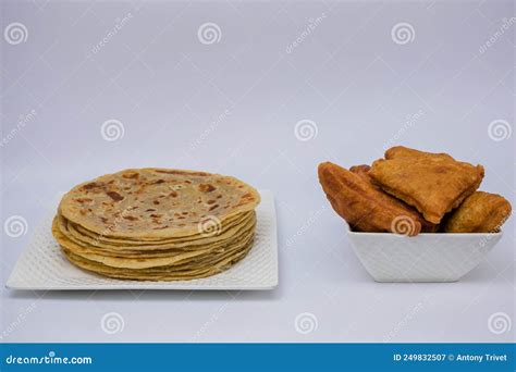 Mandazi and Chapati on the Plates and on the Floor and Spoons in ...