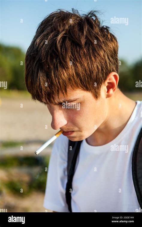 Sad Young Man smoking Cigarette on the Nature Background closeup Stock ...