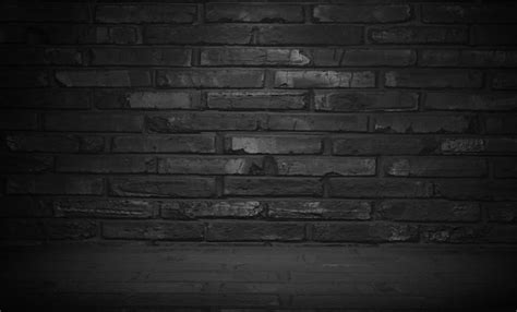 Premium Photo | Dark brick wall with a white light on it