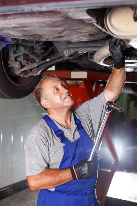 Man Mechanic Engaged in Car Repair Stock Photo - Image of activity ...