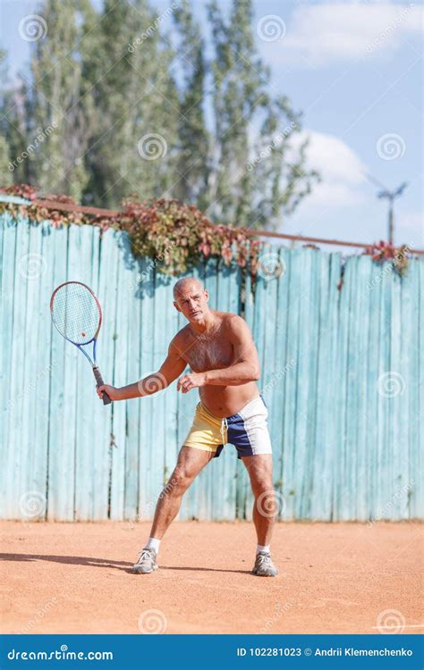 Older Men Hit the Ball on the Tennis Court. Stock Image - Image of ...