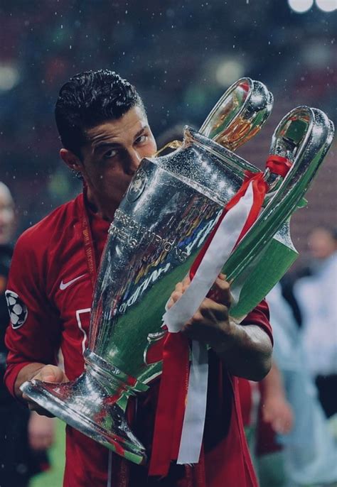 the soccer player is kissing the trophy on the field