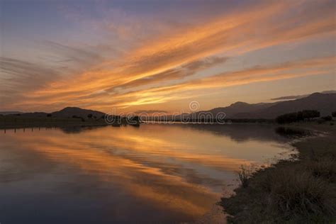 Reflections on the Lake at Sunset Stock Photo - Image of clouds ...