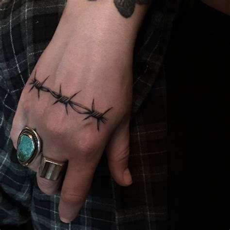 Barbed wire hand tattoo - Tattoogrid.net