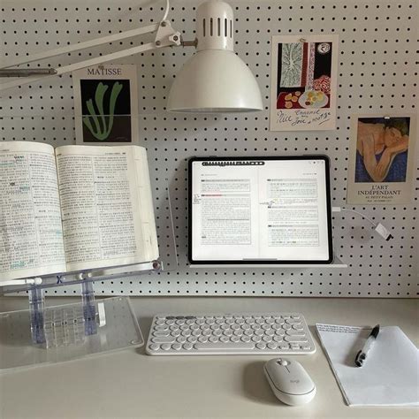 an open book sitting on top of a desk next to a computer keyboard and mouse