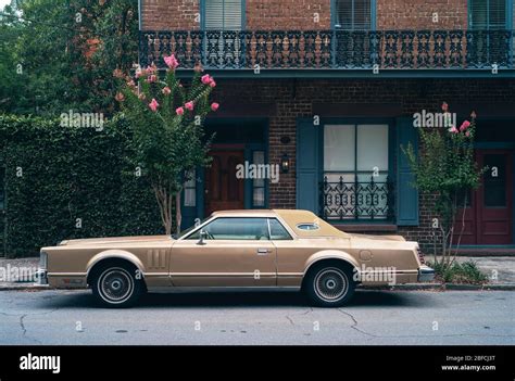 Vintage 1970s Car Parked in front of an Elegant, Southern Old Town ...