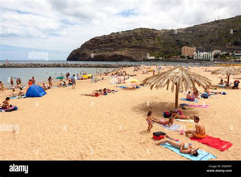 Tourists on the sandy beach of Machico, Funchal, Machico, Ilha da Stock ...