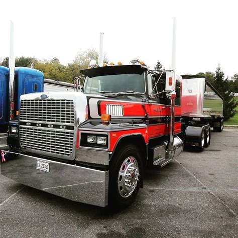 two semi trucks parked in a parking lot