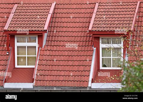 Two classic design roof windows with red tiles Stock Photo - Alamy