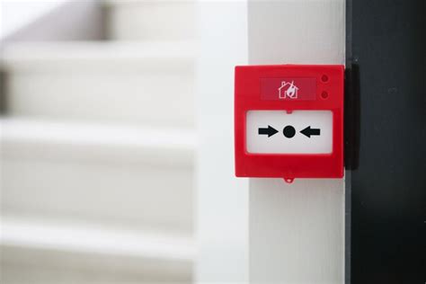 Premium Photo | Red fire alarm button on wall