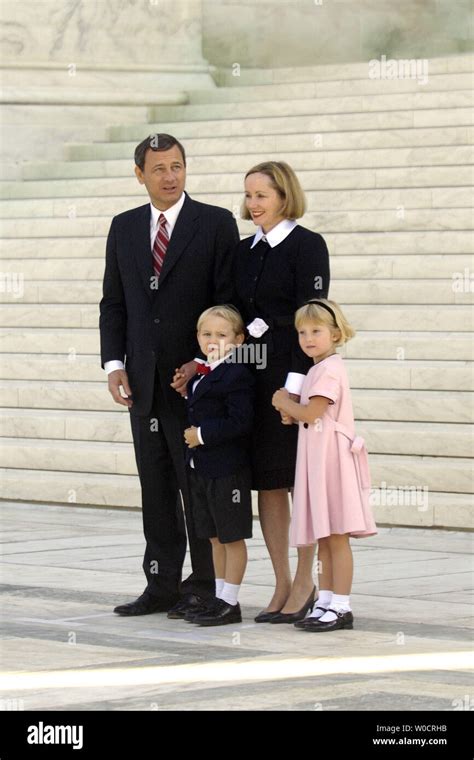 Chief Justice John G. Roberts poses with his family on the front steps ...