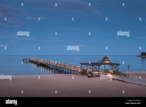 Pier on a beach in Ahus, Sweden Stock Photo - Alamy