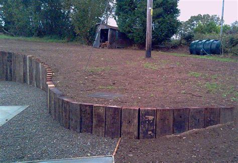 curved retaining wall from railway sleepers on end | Sloped garden ...