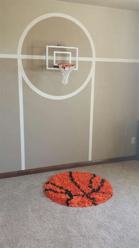 a basketball hoop in the corner of a room with an orange rug on the floor