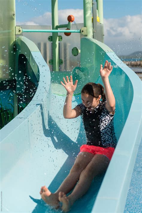 "Girl At A Waterpark Being Splashed With Water On A Slide" by Stocksy ...