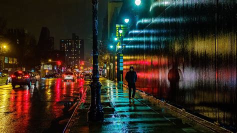 photo of man walking across the alley at night, east side, east side # ...