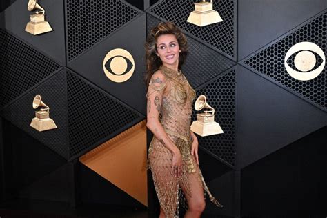 Miley Cyrus wears a naked dress made of gold safety pins at the 2024 ...