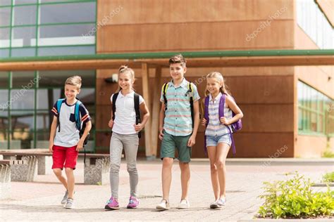 Group of happy elementary school students walking — Stock Photo © Syda ...