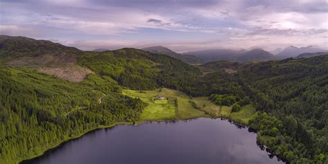 Aerial photography of lake surrounded with land and mountains under ...