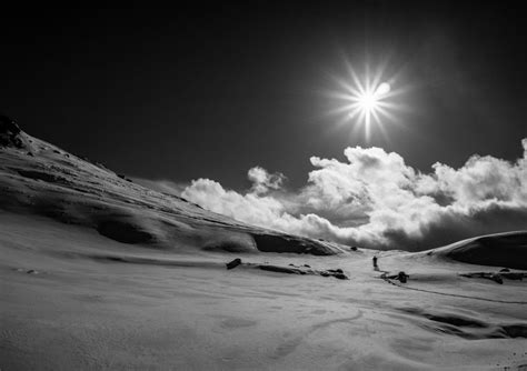 the sun shines brightly over a snowy landscape