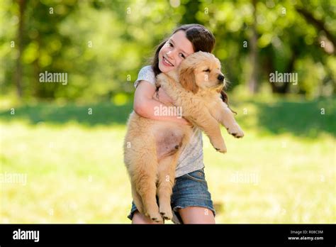 Child is hugging a puppy Stock Photo - Alamy