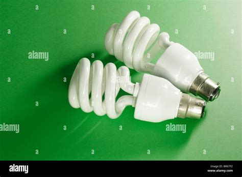 Energy saving light bulbs on green background Stock Photo - Alamy