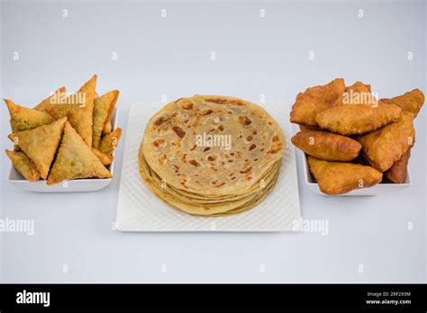 Chapati Mandazi Andazi Samosa triangular-shaped snacks on a plate on a ...