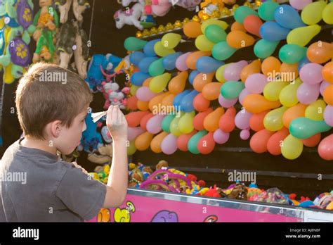 Detroit Michigan A boy aims a dart at balloons in a game at the ...