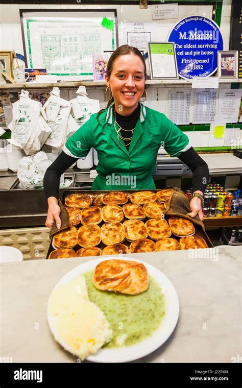 England, London, Southwark, Manze Pie and Mash Shop, Assistant Holding ...