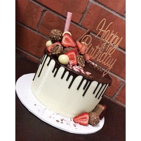 a birthday cake with chocolate and strawberries on top