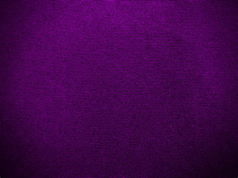 Dark purple velvet fabric texture used as background. Empty purple ...