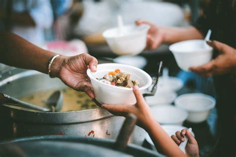 Homeless People Receive Free Charity Food from the Hands of Volunteers ...