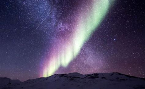 the aurora bore is shining brightly in the night sky over mountains and ...