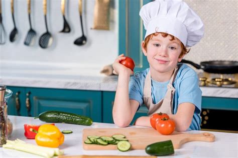 Cute Little Boy in Chef Hat and Apron Smiling at Camera while Cooking ...