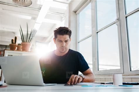 Busy young man working in office Photo (125510) - YouWorkForThem