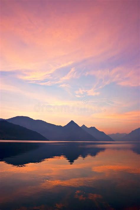 Mountain Sunrise. Beautiful sunrise over mountains, reflected on lake ...