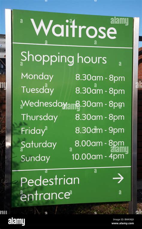 Waitrose opening hours sign Stock Photo - Alamy