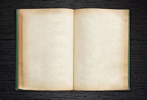 Free Photo | Old book open on dark wood background