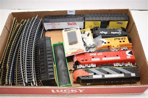 Selection of HO scale train accessories including electric engines ...