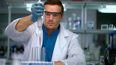 Male scientist conducting research in chemical lab. Scientist working ...