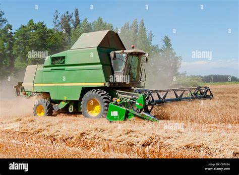 wheat harvesting machine in full work Stock Photo - Alamy