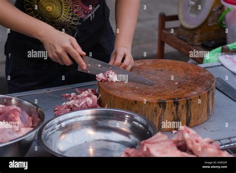 Butcher cutting pork meat Stock Photo - Alamy