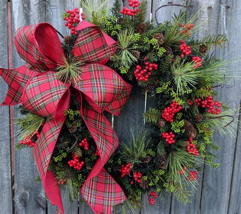 In this Christmas wreath, a rich wired plaid ribbon with a gold detail ...