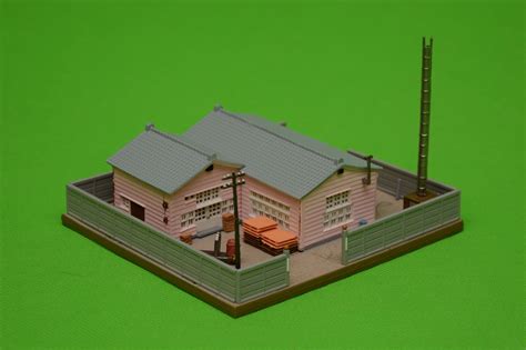 a model of a pink house on a green background