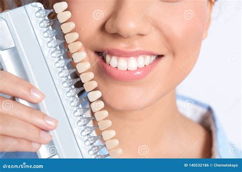 Young African-American Woman with Teeth Color Samples on Light ...