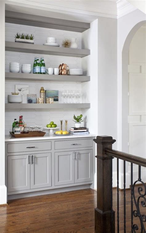 a kitchen with open shelving and wooden floors, white walls and wood ...