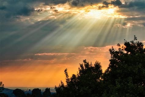 Rays of light shining through the clouds on a hazy summer day. : r/pics