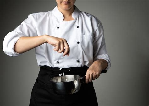 Premium Photo | Chef woman sprinkle salt cooking prepare food seasoning ...